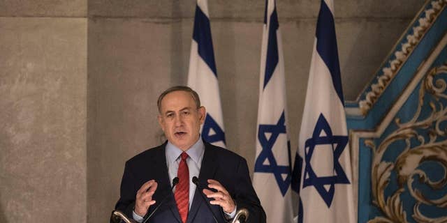 Israeli Prime Minister Benjamin Netanyahu speaks in the synagogue at the Yad Vashem Holocaust Memorial Museum, in Jerusalem, Thursday, Jan. 26, 2017. In remarks at the Holocaust ceremony on Thursday, Netanyahu said President Donald Trump understands the "danger" stemming from the Iran nuclear deal. (AP Photo/Tsafrir Abayov)