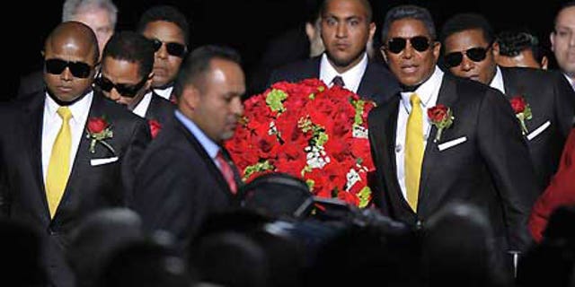 July 7: Michael Jackson's brothers carry his casket to a stage in the Staples Center for the singer's public memorial.