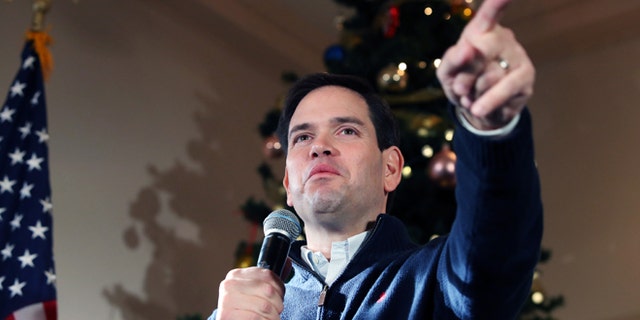 FILE - In this Monday, Dec. 21, 2015, file photo, Republican presidential candidate Sen. Marco Rubio, R-Fla., points to a potential supporter for a question during a campaign stop in Rochester, N.H. As 2015 wanes, the Florida senator is back in Iowa on Tuesday, Dec. 29, for a multi-day swing, hoping to shore up support and finish in the top tier of candidates in the Feb. 1 caucuses. (AP Photo/Mary Schwalm, File)