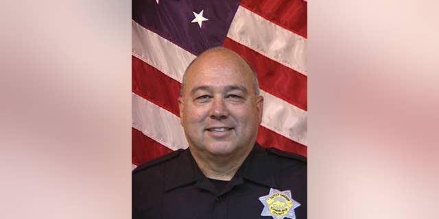 Stanislaus County Sheriff's Department Deputy Dennis Wallace is seen in an undated photo provided by the Stanislaus County, Calif., Sheriff's Department. The department says Deputy Dennis Wallace was shot and killed Sunday, Nov. 13, 2016, outside the city of Hughson, Calif., while checking on a suspicious car, and that 36-year-old suspect David Machado was arrested in Tulare County. (Stanislaus County Sheriff's Department via AP)
.