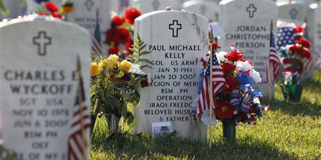 The headstone of Army Col. Paul Michael Kelly is seen at Arlington National Cemetery in Arlington, Va., where one lawmaker estimates up to 6,600 graves have been unmarked or improperly labeled.