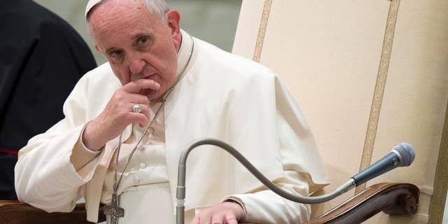 Pope Francis listens to a speech during a special audience he held for members of the FOCSIV Italian Catholic volunteers, at the Vatican, Thursday, Dec. 4, 2014. (AP Photo/Andrew Medichini)