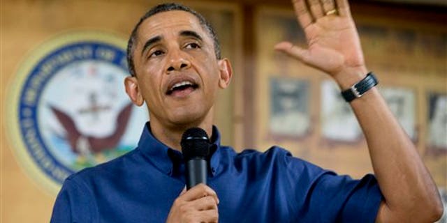 President Barack Obama speaks to members of the military and their families in Anderson Hall at Marine Corps Base Hawaii, Wednesday, Dec. 25, 2013, in Kaneohe Bay, Hawaii. The first family is in Hawaii for their annual holiday vacation. (AP Photo/Carolyn Kaster)