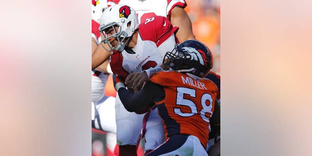 Arizona Cardinals quarterback Logan Thomas is sacked by Denver Broncos outside linebacker Von Miller (58) during the second half of an NFL football game, Sunday, Oct. 5, 2014, in Denver. (AP Photo/David Zalubowski)