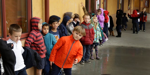 A first grade class of 30 children waits to enter a classroom at the Willow Glenn Elementary School.