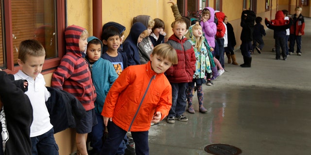 A first grade class of 30 children waits to enter a classroom at the Willow Glenn Elementary School.