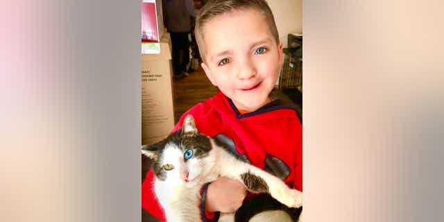 Madden Humphreys poses with his new cat, Moon.