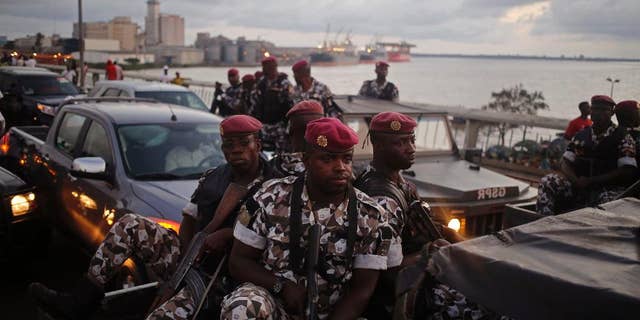 FILE-In this file photo taken Friday, Oct. 23, 2015, Ivory Coast troops provide security during an election rally of Ivory Coast incumbent President Alassane Ouattara in Abidjan, Ivory Coast. Some unidentified soldiers have launched mutinies in three cities across this West African country on Friday, Jan. 6, 2017, demanding higher pay and bringing the threat of unrest back to Africa's fastest-growing economy, authorities said. (AP Photo/Schalk van Zuydam, File)
