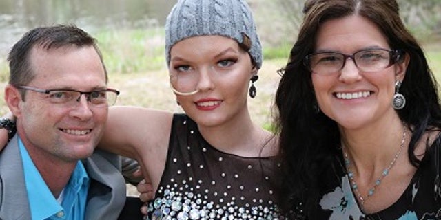 From left to right: Brett, Jenna and Becky, Jenna's mother, pose for a photo on prom night.