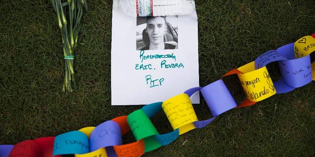 A remembrance to Eric Rivera who was killed in the mass shooting at the Pulse nightclub sits amongst a makeshift memorial to the all the victims Monday, June 13, 2016, in Orlando, Fla. A gunman killed dozens of people in a massacre at a crowded gay nightclub in Orlando on Sunday, making it the deadliest mass shooting in modern U.S. history. (AP Photo/David Goldman)