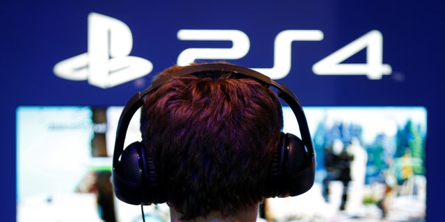 File photo: A visitors plays games on PlayStation 4 (PS4) at the Paris Games Week, a trade fair for video games in Paris, France, October 29, 2016. (REUTERS/Charles Platiau)