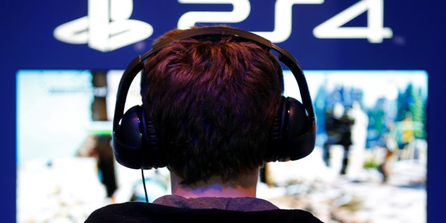 File photo: A visitors plays games on PlayStation 4 (PS4) at the Paris Games Week, a trade fair for video games in Paris, France, October 29, 2016. (REUTERS/Charles Platiau)