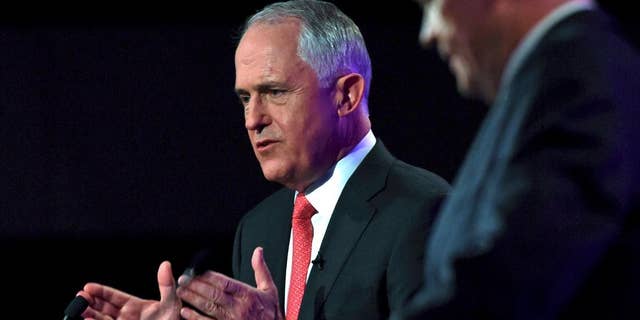 In this May 29, 2016, file photo, Australian Prime Minister Malcolm Turnbull, left, speaks as opposition leader Bill Shorten listens at a leaders' debate at the National Press Club in Canberra. Opinion polls suggest the conservative coalition government remains neck-and-neck with the center-left Labor Party opposition since the July 2, 2016 election was officially called early in May, despite efforts by both sides to break out with a range of policy announcements. (AP Photo/Tracey Nearmy/Pool, File)