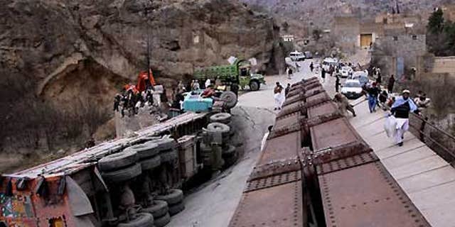 Feb. 3: A truck lies down on a bridge destroyed by alleged Islamic militants in the Pakistani tribal area of Khyber.