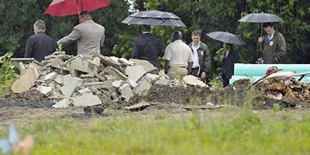 July 8: Authorities at Burr Oak Cemetery in Alsip, Ill., where dozens of graves were dug up and bodies dumped in a massive pile.