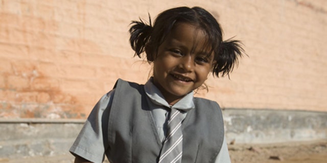Lakshmi Tatma poses in her school uniform. She was born with four arms and four legs.