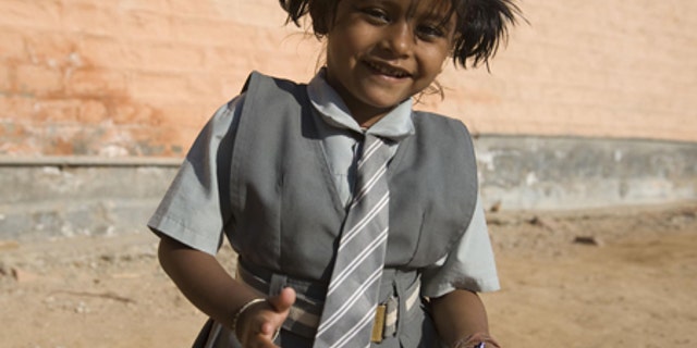 Lakshmi Tatma poses in her school uniform. She was born with four arms and four legs.