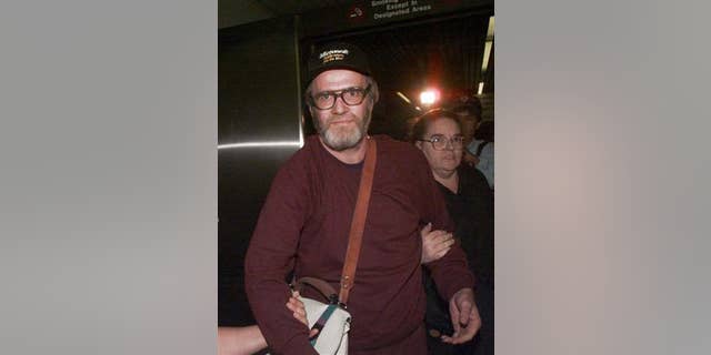 In this Oct. 13, 1995 file photo, James W. Lewis is escorted through Logan Airport after being released from a federal jail.