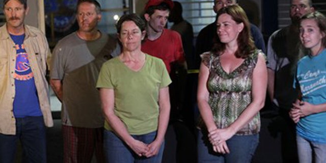 Jan. 30: American citizens pose for a photo at police headquarters in the international airport of Port-au-Prince.
