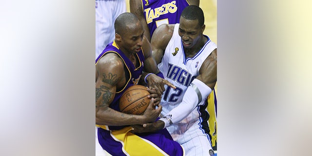 June 11: Orlando Magic's Dwight Howard (12) and Los Angeles Lakers' Kobe Bryant fight for possession in Game 4 in Orlando, Fla.