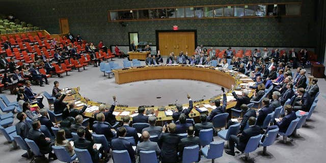 In this photo provided by the United Nations, the U.N. Security Council unanimously adopts a resolution on aviation security and safety, Thursday, Sept. 22, 2016 at United Nations headquarters. The U.N.'s most powerful body called for stepped up screening and security checks at airports worldwide to "detect and deter terrorist attacks." And it called on all countries to tighten security at airport buildings, share information about possible threats, and provide advance passenger lists so governments are aware of their transit or attempted entry. (Evan Schneider/The United Nations via AP)