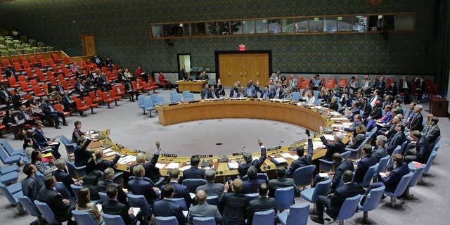 In this photo provided by the United Nations, the U.N. Security Council unanimously adopts a resolution on aviation security and safety, Thursday, Sept. 22, 2016 at United Nations headquarters. The U.N.'s most powerful body called for stepped up screening and security checks at airports worldwide to "detect and deter terrorist attacks." And it called on all countries to tighten security at airport buildings, share information about possible threats, and provide advance passenger lists so governments are aware of their transit or attempted entry. (Evan Schneider/The United Nations via AP)
