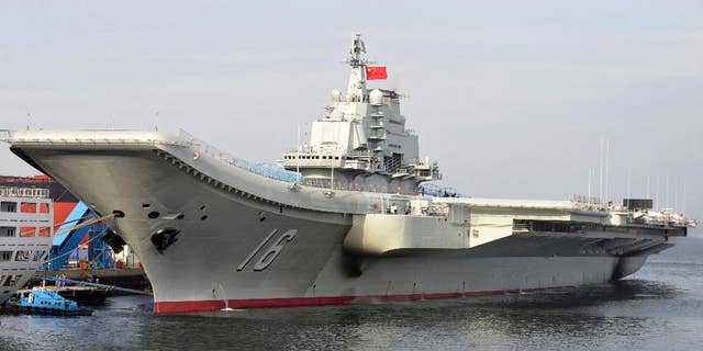 FILE - In this undated file photo released by China's Xinhua News Agency, China's aircraft carrier Liaoning berths in a port of China. China's military says its first aircraft carrier group has carried out a series of fighter launch, recovery and air combat exercises in the Yellow Sea amid tensions with the U.S. and Taiwan. The Defense Ministry announced late Friday that the Liaoning carrier group conducted the drills in the Yellow Sea in recent days and is scheduled to continue exercises farther afield. (AP Photo/Xinhua, Li Tang, File)