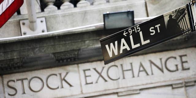 FILE - This July 16, 2013 file photo shows a Wall Street street sign outside the New York Stock Exchange in New York. U.S. stocks are starting the week sharply higher Monday, March 30, 2015, led by energy companies. (AP Photo/Mark Lennihan, File)