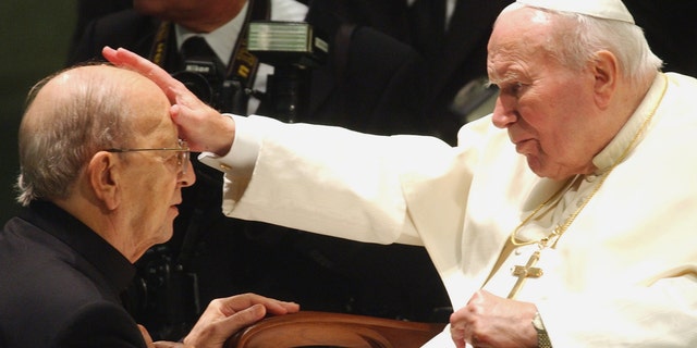 FILE - In this Nov. 30, 2004 file photo, Pope John Paul II gives his blessing to father Marcial Maciel, founder of the Legion of Christ, during a special audience at the Vatican. Pope Benedict XVI took over the Legion in 2010 after a Vatican investigation determined that Maciel had sexually molested seminarians and fathered three children by two women. Following a decision Thursday Feb. 14, 2013, by the Rhode Island Supreme Court, documents have been unsealed related to a lawsuit contesting the will of Gabrielle Mee, who left $60 million to the Legion. (AP Photo/Plinio Lepri, File)