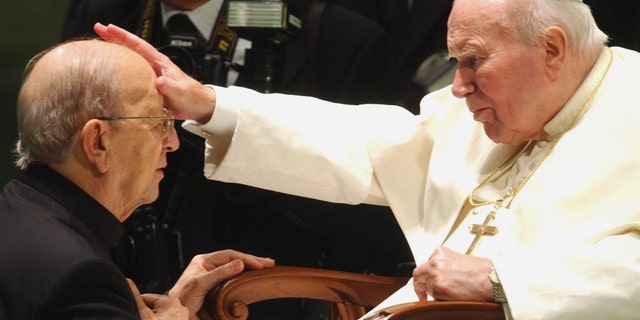 FILE - In this Nov. 30, 2004 file photo, Pope John Paul II gives his blessing to father Marcial Maciel, founder of the Legion of Christ, during a special audience at the Vatican. Pope Benedict XVI took over the Legion in 2010 after a Vatican investigation determined that Maciel had sexually molested seminarians and fathered three children by two women. Following a decision Thursday Feb. 14, 2013, by the Rhode Island Supreme Court, documents have been unsealed related to a lawsuit contesting the will of Gabrielle Mee, who left $60 million to the Legion. (AP Photo/Plinio Lepri, File)