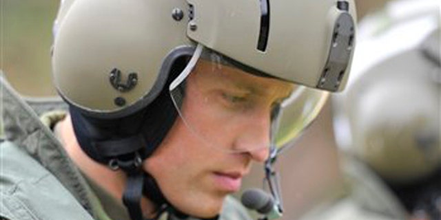 In this July 4, 2011 file photo, Britain's Prince William heads toward a Sea King helicopter for a training exercise, in Dalvay-by-the-Sea, Prince Edward Island, Canada. Prince William joined a frantic rescue mission Sunday after a cargo ship sank in the Irish Sea, leaving several crew members still missing.