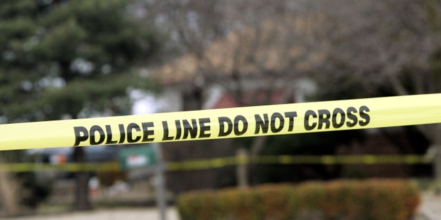 PARK CITY, KS - FEBUARY 26: Police tape hangs across the street in front of the house that Dennis Rader lives in February 26, 2005 in Park City, Kansas. Rader is the suspect whom police have arrested on suspicion of first-degree murder in connection with the 10 deaths now tied to the serial killer known as BTK. (Photo by Larry W. Smith/Getty Images)