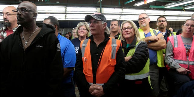 FILE: Ford Motor Co. assembly workers listen during a news conference at an assembly plant in Flat Rock, Michigan.