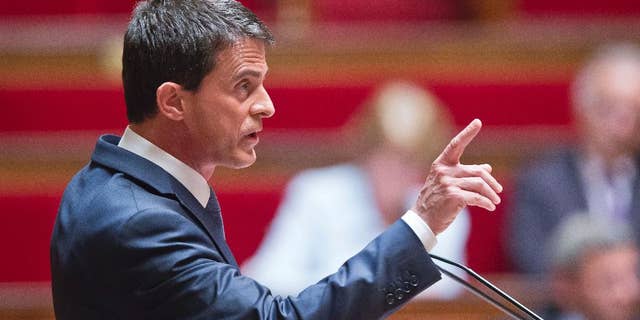 French Prime Minister Manuel Valls delivers a speech during the labor law debate at the national assembly in Paris, France, Thursday, May 12, 2016. France's government is facing a major test as lawmakers hold a no-confidence vote, prompted by a deeply divisive labor law allowing longer workdays and easier layoffs. (AP Photo/Michel Euler)
