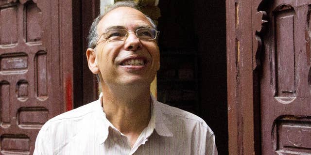 FILE - This Thursday Sept. 17, 2015 file picture shows Moroccan historian and journalist Maati Monjib standing outside the local headquarters of a human rights group in Rabat, Morocco. After a week of being on hunger strike Moroccan journalist and historian, Maati Monjib, was hospitalized Tuesday night. This is Monjib's second hunger strike in a two-month period, in protest of a travel ban. (AP Photo/Paul Schemm, File)