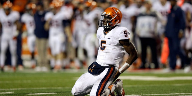 Virginia quarterback David Watford kneels on the field not being able to convert for a first down on an incomplete pass in the second half of an NCAA college football game against Maryland in College Park, Md., Saturday, Oct. 12, 2013. Maryland won 27-26. (AP Photo/Patrick Semansky)