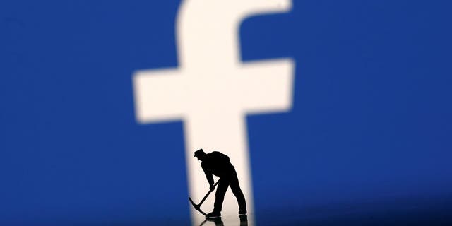 A figurine is seen in front of the Facebook logo in this illustration taken, March 20, 2018. REUTERS/Dado Ruvic - RC155C02C7D0