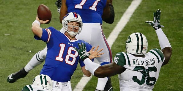 Buffalo Bills quarterback Kyle Orton throws while pressured by New York Jets defensive end Muhammad Wilkerson (96) during the first half of an NFL football game in Detroit, Monday, Nov.24, 2014. (AP Photo/Paul Sancya)