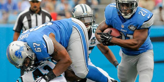 FILE - In this Sept. 14, 2014, file photo, Detroit Lions running back Reggie Bush (21) runs the ball during an NFL football game against the Carolina Panthers in Charlotte, N.C. The Lions signed Bush as a free agent before last season and the elusive running back ran for 1,006 yards, the second-highest total of his career. But so far this season, Detroit's running game has been quiet, and that's something the Lions hope to change when they host Green Bay on Sunday.(AP Photo/Mike McCarn, File)