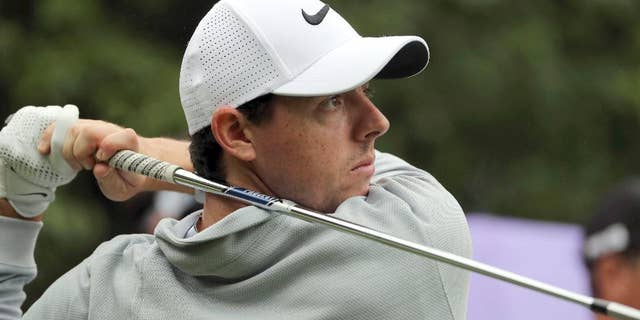 FILE - In this Thursday, Oct. 27, 2016 file photo, Rory McIlroy of Northern Ireland hits a tee shot during the WGC-HSBC Champions golf tournament at the Sheshan International Golf Club in Shanghai, China. Rory McIlroy turned in a third-round 67, to play an intriguing battle on Sunday Jan. 14, 2017. (AP Photo/Ng Han Guan, file)