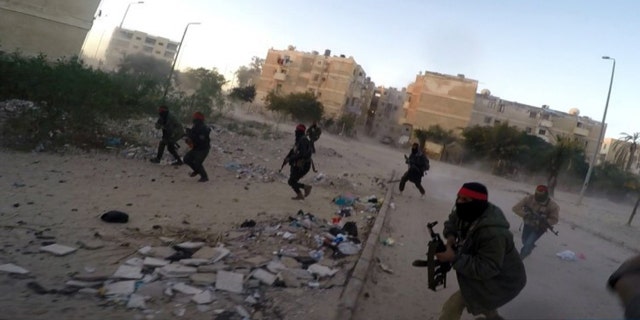 his photo posted on a file sharing website Wednesday, Jan. 11, 2017, by the Islamic State Group in Sinai, a militant organization, shows a deadly attack by militants on an Egyptian police checkpoint, in el-Arish, north Sinai, Egypt.