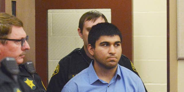 FILE - In this Sept. 26, 2016, file photo, Arcan Cetin is escorted into Skagit County District Court by Skagit County's Sheriff's Deputies, in Mount Vernon, Wash.