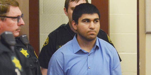 FILE - In this Sept. 26, 2016, file photo, Arcan Cetin is escorted into Skagit County District Court by Skagit County's Sheriff's Deputies, in Mount Vernon, Wash.