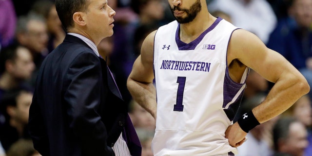 Northwestern head coach Chris Collins, left, talks to guard Drew Crawford during the first half of an NCAA college basketball game against Minnesota in Evanston, Ill., Sunday, Feb. 16, 2014. Minnesota won 54-48. (AP Photo/Nam Y. Huh)