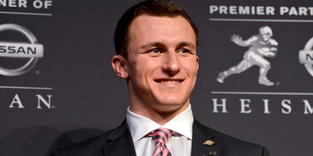 Dec. 8, 2012: Heisman Trophy winner Johnny Manziel of Texas A&M, poses with the Heisman Trophy following a news conference prior to the announcement of the winner in New York.