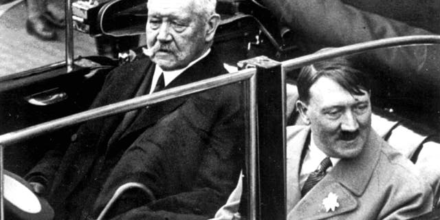 FILE May 1, 1933 file photo shows German President Paul von Hindenburg, left, and Adolf Hitler, right, in a car during a labor day celebration in Berlin. A Bavarian town has voted to strip Adolf Hitler of honorary citizenship bestowed upon him 80-years ago after an outcry prompted by their decision last week not to adopt a resolution denouncing the 1933 decision. The issue came up after an archivist discovered documents showing both Hitler and the president who appointed him, Paul von Hindenburg, had been given honorary citizenship of Dietramszell. A partial town council deadlocked in an 8-8 vote last week on the resolution, with councilors voting against saying it was not up to them to rewrite history. But town administrator Thomas Gerg said Wednesday Dec. 18, 2013 the full council voted Tuesday 21-0 both to adopt the resolution and nullify the citizenship for both men after hearing impassioned testimony from a woman who lost family in the Holocaust. (AP Photo)