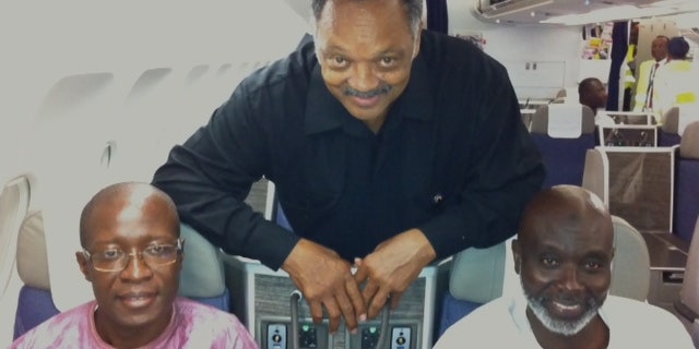 Sept. 18, 2012: The Rev. Jesse Jackson with Amadou Janneh and Tamsir Jasseh on the flight to the U.S.