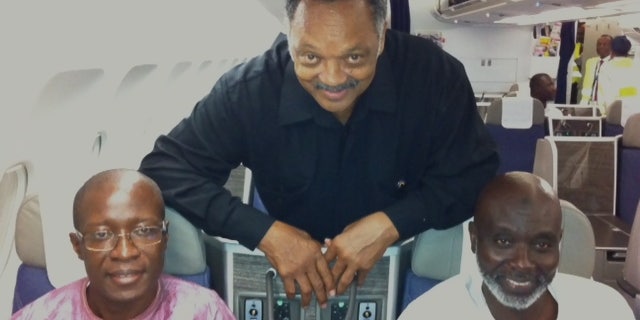 Sept. 18, 2012: The Rev. Jesse Jackson with Amadou Janneh and Tamsir Jasseh on the flight to the U.S.