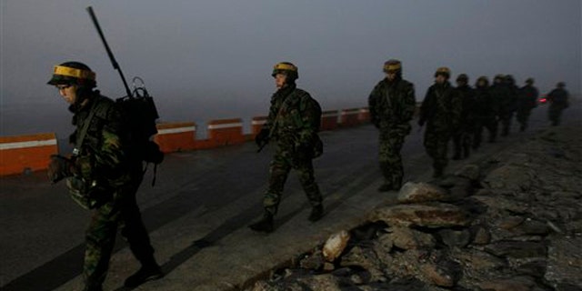 Dec. 19: South Korean Marines patrol along the coast on Yeonpyeong island, South Korea. A U.S. governor visiting North Korea called for it to show maximum restraint to planned South Korean military drills and hoped the U.N. Security Council would deliver the same message strongly as well, his office said.