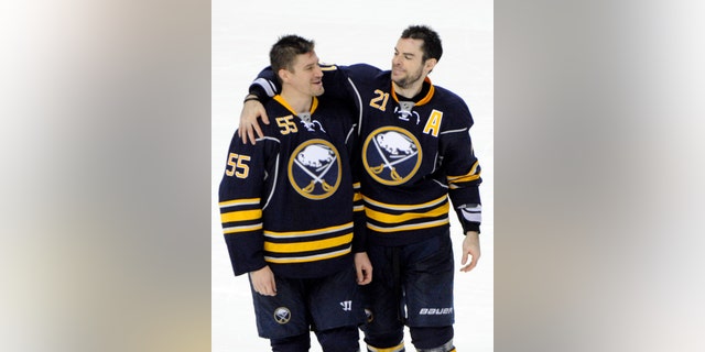 Buffalo Sabres' Jochen Hecht (55), of Germany, celebrates with Drew Stafford (21) after an NHL hockey game against the New York Islanders' in Buffalo, N.Y., Friday, April 26, 2013. Buffalo won, 2-1. (AP Photo/Gary Wiepert)